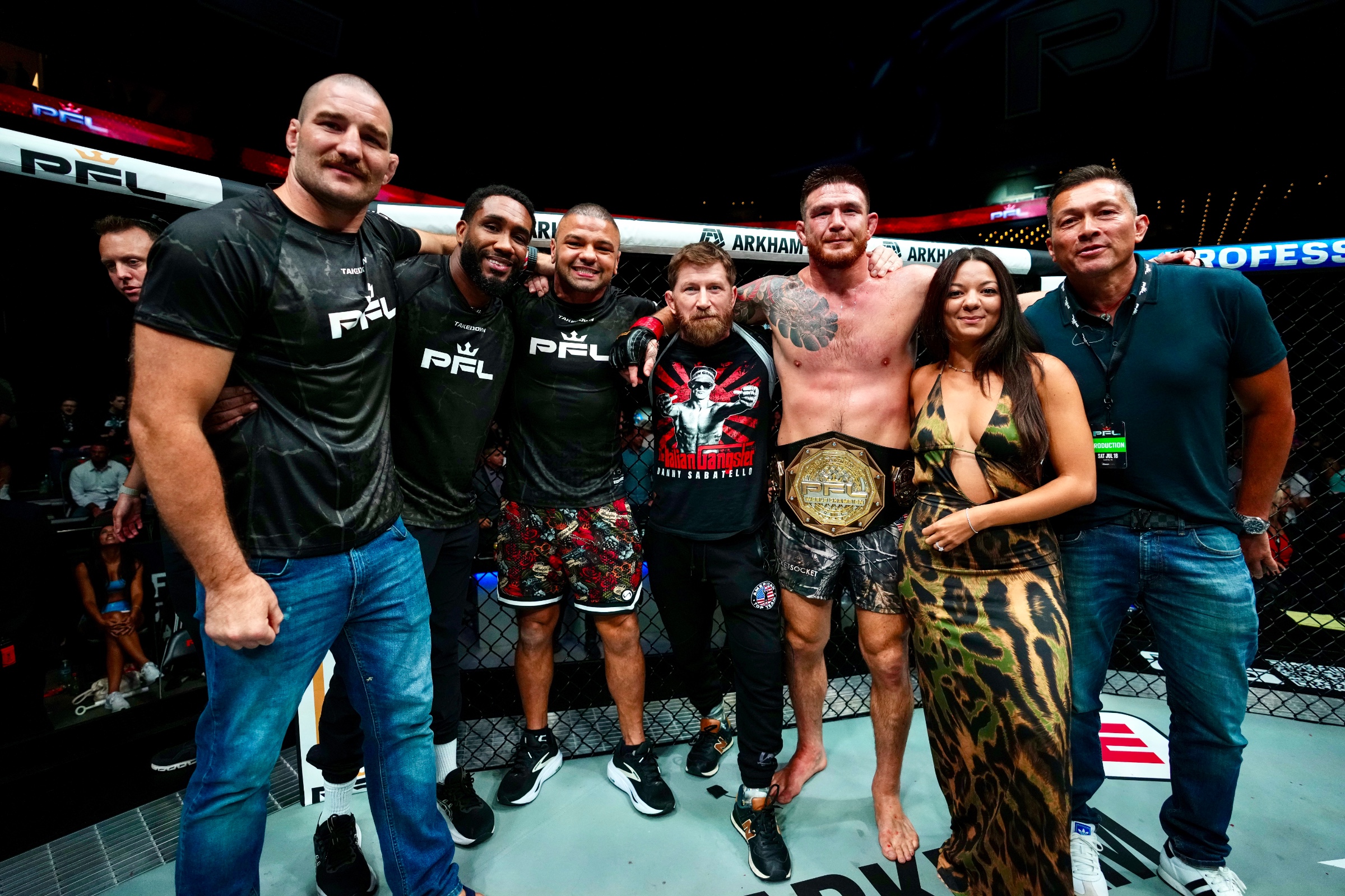 Eblen and team in the cage after winning the belt